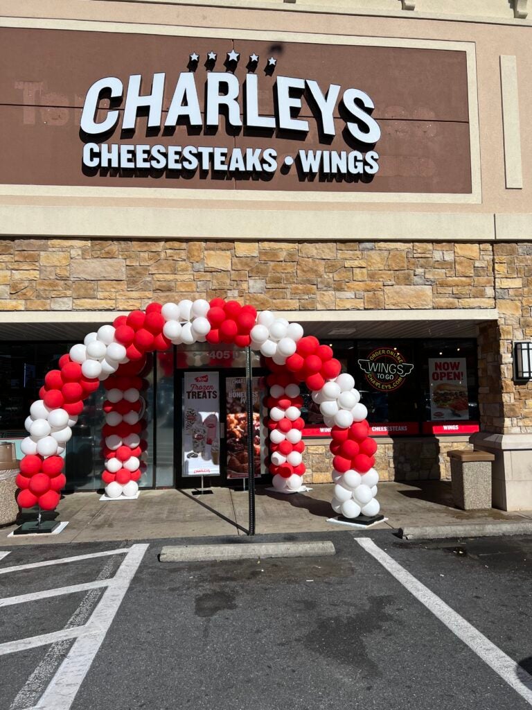 A red and white balloon arch in front of the exterior doorway of Charleys Cheesesteaks and Wings at North Frederick Ave. in Gaithersburg, Maryland.