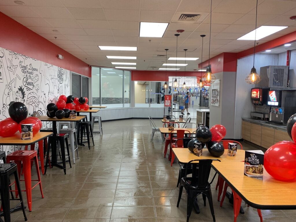 Tables and chairs with balloons in the dining area at Charleys Cheesesteaks and Wings at Walmart - Collier Blvd. in Naples, FL.